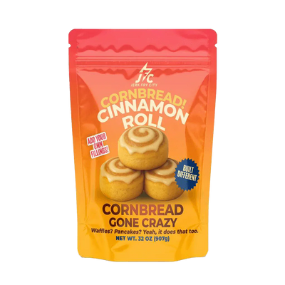 Cornbread Cinnamon Roll package with orange and pink design on a transparent background - Jerk Fry City